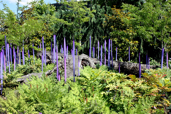 purple sculptures and a log